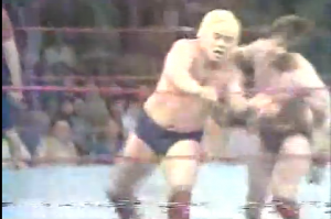 Roddy Piper tosses Buddy Rose out of the ring