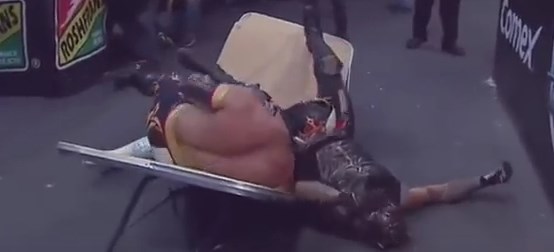 Rey Mysterio Jr. and Myzteziz crash through a table during their main event TripleMania match